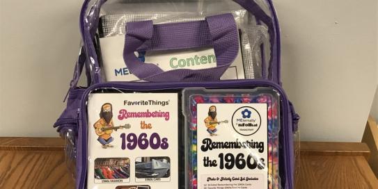 backpack filled with items for "Favorite Things: Remembering the 1960s"