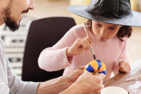 girl painting pumpkin